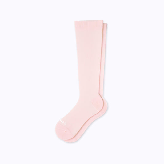 A pair of nylon knee high socks compression in rose solid